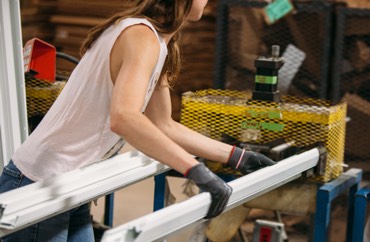 Woman working with prepairing vinyl sections for cutting and sizing